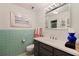 Fresh bathroom with a black vanity, a large mirror, and decorative light fixtures at 1060 N Shore Ne Dr # 6, St Petersburg, FL 33701
