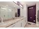 Bathroom boasts granite counters, dual sinks, white cabinets, and modern fixtures at 1060 N Shore Ne Dr # 6, St Petersburg, FL 33701