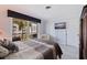 Bedroom with balcony access, television, and neutral decor at 1060 N Shore Ne Dr # 6, St Petersburg, FL 33701