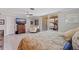 Bedroom with a king-sized bed, a ceiling fan, a TV, and a sliding glass door to a balcony at 1060 N Shore Ne Dr # 6, St Petersburg, FL 33701