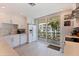 White kitchen features modern appliances, lots of counter space, and sliding glass doors to the outside at 1060 N Shore Ne Dr # 6, St Petersburg, FL 33701