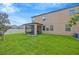 Backyard with a manicured green lawn, privacy fence, and screened-in lanai at 11464 Chilly Water Ct, Riverview, FL 33569