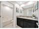 Bathroom featuring dual sinks, granite countertops, and a shower-tub combo at 11464 Chilly Water Ct, Riverview, FL 33569