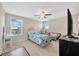 Neutral bedroom featuring a ceiling fan, carpet, natural light, and eclectic furnishings at 11464 Chilly Water Ct, Riverview, FL 33569