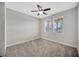 Cozy bedroom featuring a ceiling fan, neutral colors, and two windows with views at 11464 Chilly Water Ct, Riverview, FL 33569