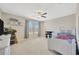Bright bedroom with a ceiling fan, neutral walls, carpet, and natural light at 11464 Chilly Water Ct, Riverview, FL 33569