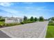 Welcoming entrance to Crestview Lakes community with brick-paved drive and manicured landscaping at 11464 Chilly Water Ct, Riverview, FL 33569