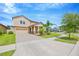 Beautiful exterior of a two-story home with a brick driveway, lush lawn, and mature landscaping at 11464 Chilly Water Ct, Riverview, FL 33569