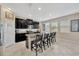 Modern kitchen featuring sleek cabinets, stainless steel appliances, and a center island with barstool seating at 11464 Chilly Water Ct, Riverview, FL 33569