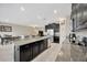 Open kitchen featuring a large island with seating, modern appliances, and an open view to the living area at 11464 Chilly Water Ct, Riverview, FL 33569