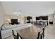 Open concept living room and kitchen with a large couch and dark cabinets at 11464 Chilly Water Ct, Riverview, FL 33569