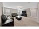 Spacious living room with plush carpeting, comfortable seating, and ample natural light at 11464 Chilly Water Ct, Riverview, FL 33569