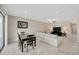 Open-concept living space features a cozy dining area, a comfortable sofa, and a modern entertainment setup at 11464 Chilly Water Ct, Riverview, FL 33569