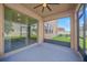 Screened patio with a ceiling fan overlooking a green lawn and fencing at 11464 Chilly Water Ct, Riverview, FL 33569