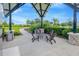 Covered seating area offering shade, a place to rest, and views of the playground and green spaces at 11464 Chilly Water Ct, Riverview, FL 33569