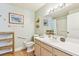 Well-lit bathroom with neutral-toned vanity and sink with storage at 12413 Dawn Vista Dr, Riverview, FL 33578