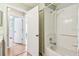 Bright bathroom with white-tiled shower and a doorway to additional rooms at 12413 Dawn Vista Dr, Riverview, FL 33578