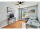 Bright bedroom with beach paintings, dresser, wood floor, and ceiling fan at 12413 Dawn Vista Dr, Riverview, FL 33578
