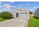 Charming single-story home featuring a well-manicured lawn and attached one car garage at 12413 Dawn Vista Dr, Riverview, FL 33578