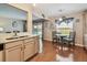 Bright eat-in kitchen featuring wood floors, stainless steel sink, and backyard views at 12413 Dawn Vista Dr, Riverview, FL 33578