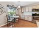 Sunlit kitchen with stainless steel appliances, light countertops, and charming breakfast nook at 12413 Dawn Vista Dr, Riverview, FL 33578