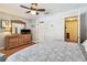 Bright main bedroom with wood floors leading to the closet and bathroom at 12413 Dawn Vista Dr, Riverview, FL 33578