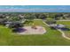 Aerial view of the community playground, featuring colorful play equipment and ample green space at 12413 Dawn Vista Dr, Riverview, FL 33578