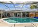 Relaxing pool area with lounge chairs and covered patio, ideal for enjoying sunny days at 12413 Dawn Vista Dr, Riverview, FL 33578