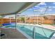 Inviting in-ground pool surrounded by a screened enclosure, perfect for relaxation and recreation at 12413 Dawn Vista Dr, Riverview, FL 33578