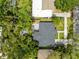 Aerial view of a house with a backyard featuring a patio, fire pit and lush trees and greenery at 1275 Palm St, Clearwater, FL 33755