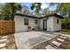 Cozy backyard featuring a brick patio, grill, and lush greenery, perfect for relaxing and entertaining at 1275 Palm St, Clearwater, FL 33755