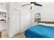 Bright bedroom with blue bedding, ceiling fan, closet, and window for natural light at 1275 Palm St, Clearwater, FL 33755