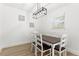 Bright dining room featuring a modern light fixture and matching dark-stained wood dining set at 1275 Palm St, Clearwater, FL 33755