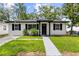 Charming single-story home featuring a well-maintained lawn and freshly painted exterior at 1275 Palm St, Clearwater, FL 33755