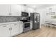Well-appointed kitchen featuring stainless steel appliances and sleek white cabinets at 1275 Palm St, Clearwater, FL 33755