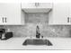 Close-up of sleek kitchen sink with modern fixtures and stylish backsplash at 1275 Palm St, Clearwater, FL 33755