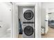 Convenient laundry closet with stacked washer/dryer, with extra space for supplies and access to bathroom at 1275 Palm St, Clearwater, FL 33755