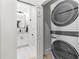 Modern laundry room features a stacked washer and dryer, maximizing space and efficiency at 1275 Palm St, Clearwater, FL 33755