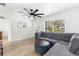 Comfortable living room with large window, plush sectional, and contemporary ceiling fan at 1275 Palm St, Clearwater, FL 33755