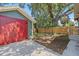 The backyard features a freshly painted garage door, wood fence, and plenty of sunshine at 1435 Prescott S St, St Petersburg, FL 33712