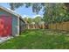 Large grassy backyard featuring a wood fence adding privacy and charm to the outdoor space at 1435 Prescott S St, St Petersburg, FL 33712