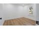 This bright bedroom has vinyl flooring, a large window, and fresh white paint at 1435 Prescott S St, St Petersburg, FL 33712