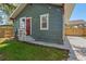 Charming home featuring a red door, nice landscape, and matching detached carport for a cohesive exterior at 1435 Prescott S St, St Petersburg, FL 33712