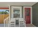 Charming front porch detail with seating and a red front door at 1435 Prescott S St, St Petersburg, FL 33712