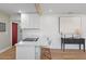 Bright kitchen with modern white cabinets, quartz countertops, island with bar seating, and stainless cooktop at 1435 Prescott S St, St Petersburg, FL 33712