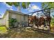 Landscaped backyard featuring a screened-in pool, patio, and mature plantings at 15217 Octavia Ln, Odessa, FL 33556