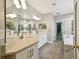 Bright bathroom features double sinks, vanity, bathtub, and a glass enclosed shower at 15217 Octavia Ln, Odessa, FL 33556