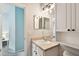 Half bathroom with an elongated vanity, decorative mirror, and vanity at 15217 Octavia Ln, Odessa, FL 33556