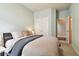 Bedroom showcasing a serene atmosphere with natural light from the window and ample storage with the closet at 15217 Octavia Ln, Odessa, FL 33556