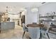 The dining area features a modern light fixture, complementing the open kitchen's design at 15217 Octavia Ln, Odessa, FL 33556